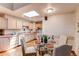 Bright eat-in kitchen features a skylight, white appliances, and a round table with seating for four at 753 S Utica St, Denver, CO 80219