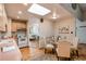 Open kitchen featuring a skylight, adjacent dining space, and vintage appliances at 753 S Utica St, Denver, CO 80219