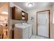 Laundry room featuring a washer and dryer set, as well as overhead cabinets at 753 S Utica St, Denver, CO 80219