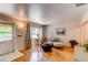 Bright living room with hardwood floors, a cozy seating area, and a clear view to the front door at 753 S Utica St, Denver, CO 80219