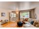 Cozy living room featuring hardwood floors, a plush sofa, and ample natural light from a large window at 753 S Utica St, Denver, CO 80219