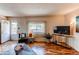 Living room featuring hardwood floors, modern fixtures, and access to outdoor space at 753 S Utica St, Denver, CO 80219