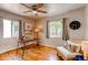Bright office space with hardwood floors, two windows, and neutral paint at 753 S Utica St, Denver, CO 80219