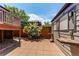 Tiled patio features a fenced yard with lush bushes and unique outdoor benches at 753 S Utica St, Denver, CO 80219