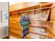 Spacious wood-lined walk-in closet featuring shelves, hanging rods, and a mirror at 753 S Utica St, Denver, CO 80219