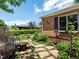 Serene backyard with a stone patio, lush landscaping, and a cozy seating area, perfect for outdoor relaxation at 3580 Krameria St, Denver, CO 80207