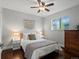 Cozy bedroom featuring a comfortable bed, decorative accents, and natural light from the leaded glass window at 3580 Krameria St, Denver, CO 80207