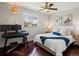 Bright bedroom with a comfortable bed, stylish decor, leaded glass window, and a dedicated workspace with monitors at 3580 Krameria St, Denver, CO 80207
