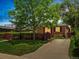 Charming brick home with a well-maintained lawn and a inviting driveway leading to the property at 3580 Krameria St, Denver, CO 80207