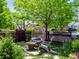 Inviting outdoor seating area with unique egg chair, garden, stepping stones, and picket fence at 3580 Krameria St, Denver, CO 80207