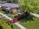 Charming brick home with a beautiful, landscaped front yard and red picket fence at 3580 Krameria St, Denver, CO 80207
