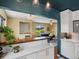 Open-concept kitchen view, showcasing modern white cabinets, quartz countertops, and seamless transition to living area at 3580 Krameria St, Denver, CO 80207