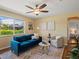 Sun-filled living room features a large window, modern ceiling fan and updated decor at 3580 Krameria St, Denver, CO 80207