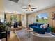 Open living room with adjacent dining area, lots of natural light, and ceiling fan at 3580 Krameria St, Denver, CO 80207