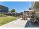A large backyard features a patio, seating and a porch swing and lush green grass at 5102 S Lisbon Way, Centennial, CO 80015