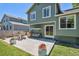 Outdoor patio with patio table and seating and a porch swing off the back of the green home at 5102 S Lisbon Way, Centennial, CO 80015