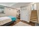 Basement living space with stairs, storage, and a bedroom area with natural light at 5102 S Lisbon Way, Centennial, CO 80015