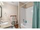 Dual view of a bathroom with a granite countertop vanity and tiled tub-shower combo at 5102 S Lisbon Way, Centennial, CO 80015