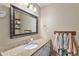 Bathroom featuring a granite countertop vanity, large mirror, and decorative towel rack at 5102 S Lisbon Way, Centennial, CO 80015