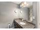 Bathroom features a granite countertop and a large mirror, plus stylish wall accents at 5102 S Lisbon Way, Centennial, CO 80015