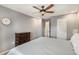 Spacious bedroom featuring a ceiling fan, neutral walls, and a wooden dresser at 5102 S Lisbon Way, Centennial, CO 80015