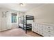 ' bedroom with a bunk bed, large dresser, and natural light from the window at 5102 S Lisbon Way, Centennial, CO 80015