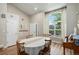 Bright dining area with a large window and wood-look flooring, creating a welcoming space at 5102 S Lisbon Way, Centennial, CO 80015