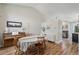 Charming dining area with a table set for four, a piano, and wood-look flooring at 5102 S Lisbon Way, Centennial, CO 80015