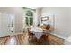 Inviting dining room with ample natural light, wood floors, and a piano at 5102 S Lisbon Way, Centennial, CO 80015