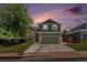 Charming two-story home with a well-manicured lawn, mature tree, and an inviting two-car garage at 5102 S Lisbon Way, Centennial, CO 80015