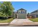 Exterior of the house with a two-car garage, green siding, and front yard at 5102 S Lisbon Way, Centennial, CO 80015