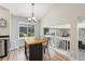 Bright kitchen features a wooden island, modern lighting, and a view of the landscaped backyard at 5102 S Lisbon Way, Centennial, CO 80015