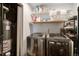The laundry room has a washer and dryer, water heater, and shelves for storage at 5102 S Lisbon Way, Centennial, CO 80015