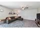 Comfortable living room features wood paneling, stylish decor, ceiling fan and plenty of space at 5102 S Lisbon Way, Centennial, CO 80015