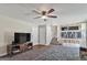 Open living area leads into kitchen with stairs, and features a ceiling fan at 5102 S Lisbon Way, Centennial, CO 80015