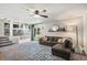 Comfortable living room with ceiling fan, sliding glass door and a view to the kitchen at 5102 S Lisbon Way, Centennial, CO 80015
