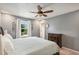 This bright main bedroom boasts natural light, neutral colors and a ceiling fan at 5102 S Lisbon Way, Centennial, CO 80015