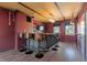 Unique bar featuring hardwood floors, exposed beams and seating for five at 166 S Rainbow Trl, Evergreen, CO 80439
