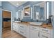 Modern bathroom with double sinks, granite countertops, and white cabinetry at 166 S Rainbow Trl, Evergreen, CO 80439