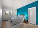Stylish bedroom with a queen bed, light wood floors and bright accent wall at 166 S Rainbow Trl, Evergreen, CO 80439