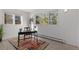 Bright bedroom featuring a light wood floor, large windows and an office desk at 166 S Rainbow Trl, Evergreen, CO 80439
