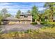 Stunning two-story home with an attached three-car garage and beautiful natural landscaping at 166 S Rainbow Trl, Evergreen, CO 80439