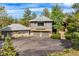 Stunning exterior view featuring an attached garage, stylish design, and well-kept landscaping at 166 S Rainbow Trl, Evergreen, CO 80439