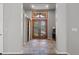Foyer with tile flooring, decorative double doors, accent lighting and barn-style closet doors at 166 S Rainbow Trl, Evergreen, CO 80439