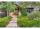 Charming front entrance with well-maintained landscaping, stone accents, and a welcoming wooden door at 166 S Rainbow Trl, Evergreen, CO 80439