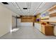 A large garage with white cabinets, hanging shelves and a workbench at 166 S Rainbow Trl, Evergreen, CO 80439