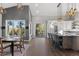 Open kitchen and dining area with white cabinets, stainless appliances, granite countertops, and an outdoor view at 166 S Rainbow Trl, Evergreen, CO 80439