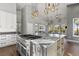 Gourmet kitchen features granite counters, stainless appliances, custom cabinets, and a large center island at 166 S Rainbow Trl, Evergreen, CO 80439