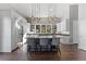Modern kitchen featuring a large island with seating, pendant lighting, and views of the natural landscape at 166 S Rainbow Trl, Evergreen, CO 80439