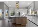 Bright kitchen with an island, stainless steel appliances, lots of cabinets, granite countertops and a dining area at 166 S Rainbow Trl, Evergreen, CO 80439
